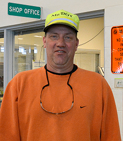 Photo of Ron McDeid, Metro District, wearing orange sweatshirt and yellow-green MnDOT hat